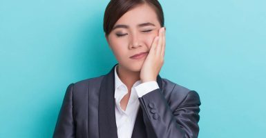 Businesswoman has tooth ache
